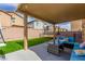 Covered patio with seating area, string lights and a view of the backyard at 4036 Floating Fern Ave, North Las Vegas, NV 89084