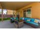 Covered patio with seating area, string lights and a view of the backyard at 4036 Floating Fern Ave, North Las Vegas, NV 89084