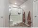 Clean shower with glass enclosure, seat, and modern fixtures at 4036 Floating Fern Ave, North Las Vegas, NV 89084