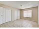 Bright bedroom with closet, featuring tiled floors and a window offering natural light at 4721 Via Renaldo, Las Vegas, NV 89103