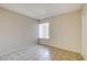 This cozy bedroom features tile flooring, a large window, and a closet for ample storage at 4721 Via Renaldo, Las Vegas, NV 89103