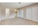 Well-lit bedroom showcasing tiled flooring, a closet, and doorway leading to bathroom and laundry room at 4721 Via Renaldo, Las Vegas, NV 89103