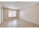 Spacious bedroom with tile flooring, natural light from window, and closet with sliding doors at 4721 Via Renaldo, Las Vegas, NV 89103