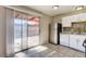 Bright kitchen with stainless steel refrigerator and sliding glass door to backyard at 4721 Via Renaldo, Las Vegas, NV 89103