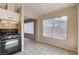 Open kitchen and dining area with black appliances and ceramic tile flooring at 4721 Via Renaldo, Las Vegas, NV 89103