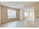 Open-concept living room with tile flooring and bright windows at 4721 Via Renaldo, Las Vegas, NV 89103