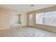 Open living room with tile flooring, leading to a bright window and adjacent spaces at 4721 Via Renaldo, Las Vegas, NV 89103