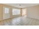 Open living room with tiled floors, a bright window, and seamless transition to other spaces at 4721 Via Renaldo, Las Vegas, NV 89103