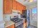 Stainless steel stove and oven, wood cabinets in kitchen at 4800 Nara Vista Way # 204, Las Vegas, NV 89103