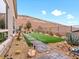 Landscaped backyard with artificial turf and walkway at 49 Strada Caruso, Henderson, NV 89011