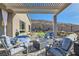 Relaxing patio with pergola and fire pit at 49 Strada Caruso, Henderson, NV 89011