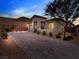 Single-story home with a paved driveway and desert landscaping at 49 Strada Caruso, Henderson, NV 89011