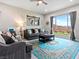 Bright living room with a cozy seating area and large window at 49 Strada Caruso, Henderson, NV 89011