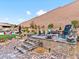 Stone patio with seating area and landscaping at 49 Strada Caruso, Henderson, NV 89011