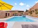 Relaxing pool area with patio furniture and umbrella at 49 Strada Caruso, Henderson, NV 89011