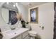 Bright bathroom featuring a round mirror, modern vanity, and decorative accents at 526 Sellers Pl, Henderson, NV 89011