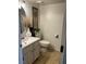 Well-lit bathroom with stylish vanity, modern fixtures, and neutral earth-tone tiling at 526 Sellers Pl, Henderson, NV 89011