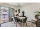 Elegant dining room with a wood table and gray velvet chairs at 526 Sellers Pl, Henderson, NV 89011