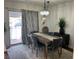 Elegant dining room featuring a chandelier, a dark wood table, and outdoor access at 526 Sellers Pl, Henderson, NV 89011