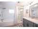 Bathroom featuring a tub, shower, patterned tile, and a gray vanity at 5515 Coley Ave, Las Vegas, NV 89146