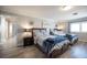 Bright bedroom featuring two beds with wood frames, wood floors, and lots of natural light at 5515 Coley Ave, Las Vegas, NV 89146