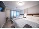 Bedroom featuring two beds, a large TV, wood floors, and blue accents at 5515 Coley Ave, Las Vegas, NV 89146