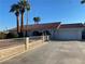 Front view of a white single-story home with a garage and fence at 5515 Coley Ave, Las Vegas, NV 89146