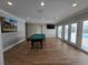 Game room with pool table, hardwood floors, and sliding glass doors to backyard at 5515 Coley Ave, Las Vegas, NV 89146