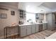 Charming kitchen design with display shelves, gray cabinetry, and stainless steel sink at 5515 Coley Ave, Las Vegas, NV 89146