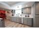 Well-lit kitchen area with white backsplash, open shelving, and stainless steel appliances at 5515 Coley Ave, Las Vegas, NV 89146