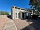 Exterior view of a light-colored townhouse with a walkway and small yard at 569 Sellers Pl # 569, Henderson, NV 89011