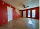 Living room with red walls, tile floors, and a view of the staircase at 569 Sellers Pl # 569, Henderson, NV 89011