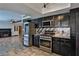 Modern kitchen with stainless steel appliances and dark cabinets at 722 Barrie Ct, Henderson, NV 89002