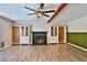 Living room with wood floors, fireplace, and ceiling fan at 722 Barrie Ct, Henderson, NV 89002