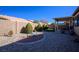 Landscaped backyard with covered patio and decorative fountain at 7436 Wagonwheel Ranch Way, Las Vegas, NV 89113