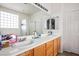 Double vanity bathroom with a walk-in shower and large mirror at 7436 Wagonwheel Ranch Way, Las Vegas, NV 89113