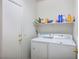 Convenient laundry room with washer, dryer, and storage shelves at 7436 Wagonwheel Ranch Way, Las Vegas, NV 89113