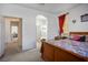 Main bedroom with a walk-through bathroom and carpet flooring at 7436 Wagonwheel Ranch Way, Las Vegas, NV 89113