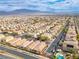 Stunning aerial showcasing the neighborhood, complete with a sparkling blue pool and solar panels on many roofs at 7611 Redcloud Peak St, Las Vegas, NV 89166