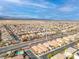 Sprawling aerial view showcases a neighborhood with lush landscaping and a community pool at 7611 Redcloud Peak St, Las Vegas, NV 89166