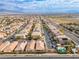 Expansive aerial view of a well-maintained community with desert landscaping and mountain views in the distance at 7611 Redcloud Peak St, Las Vegas, NV 89166