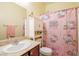 Bathroom featuring vanity, a toilet, Hello Kitty-themed shower curtain and natural light at 7611 Redcloud Peak St, Las Vegas, NV 89166