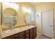 Bathroom featuring double sinks, framed mirrors, great lighting, and walk-in shower at 7611 Redcloud Peak St, Las Vegas, NV 89166