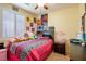 Bedroom featuring playful decor, comfortable bed, and ample natural light from shuttered window at 7611 Redcloud Peak St, Las Vegas, NV 89166