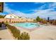 Beautiful community pool featuring ample seating, meticulously maintained landscaping, and shaded areas at 7611 Redcloud Peak St, Las Vegas, NV 89166