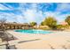 Expansive community pool featuring abundant lounge chairs and beautifully maintained landscaping at 7611 Redcloud Peak St, Las Vegas, NV 89166