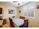 Cozy dining area with window shutters, dining table and chairs, and a ceiling fan at 7611 Redcloud Peak St, Las Vegas, NV 89166