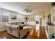 Inviting living room showcasing hardwood floors, comfortable sectional, and seamless flow to kitchen at 7611 Redcloud Peak St, Las Vegas, NV 89166