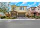 Two-story house with stone accents and a two-car garage at 7747 Harthill Park Ave, Las Vegas, NV 89113