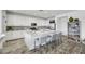 Modern kitchen with white cabinetry, granite island, and breakfast bar at 7747 Harthill Park Ave, Las Vegas, NV 89113